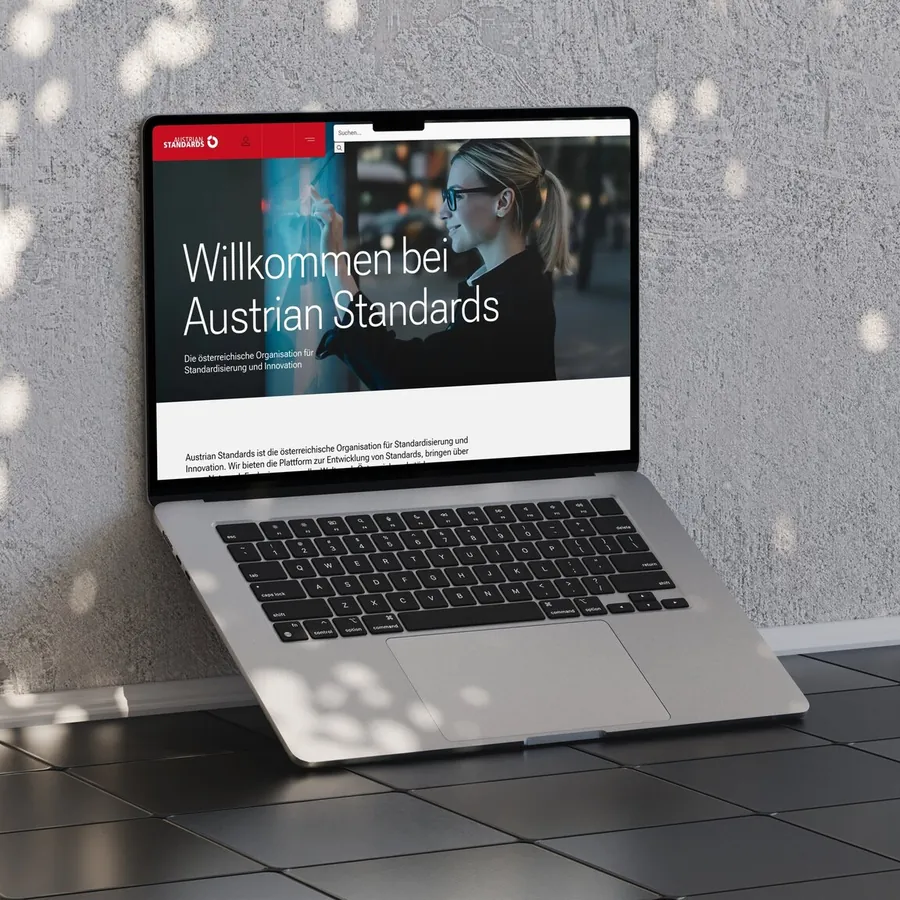 Website von Austrian Standards auf einem Laptop auf Fliesenboden
